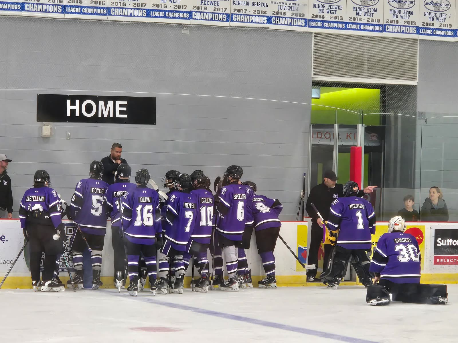 Jr. Mustangs Hockey players gathered at the home bench